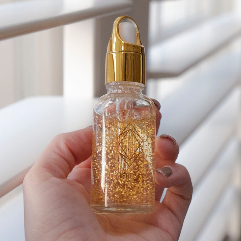 24K Nanogold Face Serum With Hand Holding Bottle